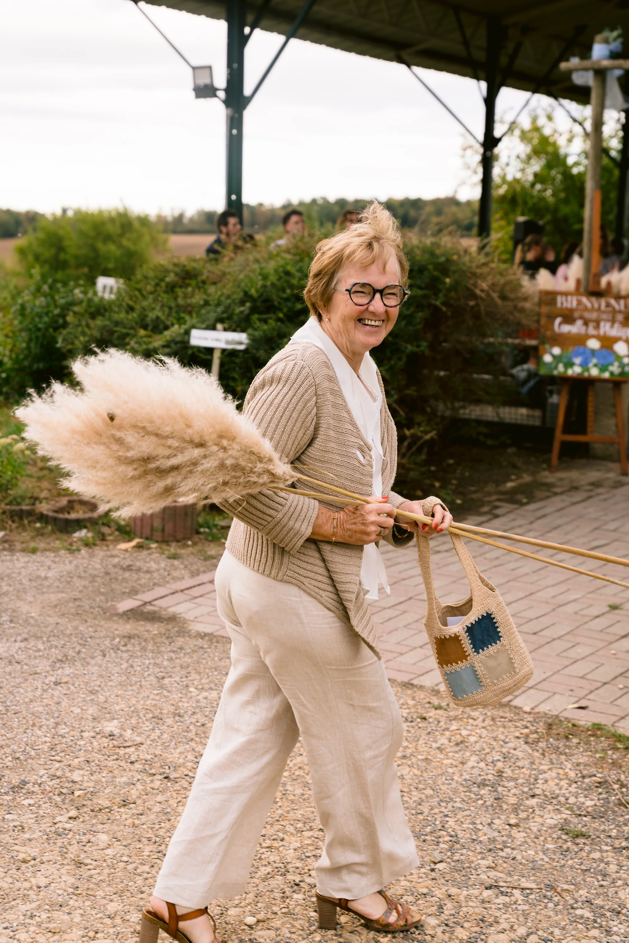 Une invitée s'amuse avec un bouquet d'herbes de la décoration
